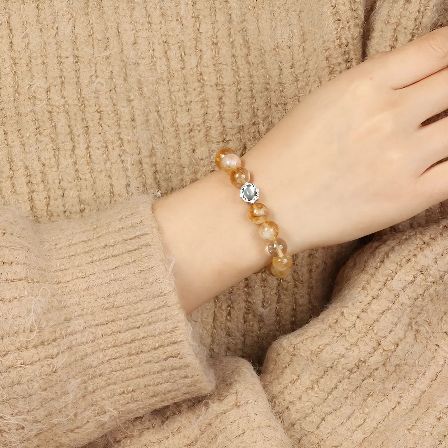 Polished citrine crystal bracelet with 10mm geometric beads on wrist