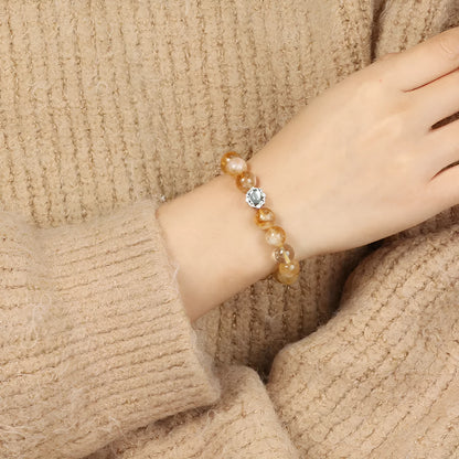 Polished citrine crystal bracelet with 10mm geometric beads on wrist