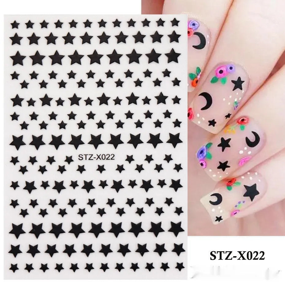 Assortment of black and silver nail sticker designs including cartoon and French tip patterns on a plastic sheet.