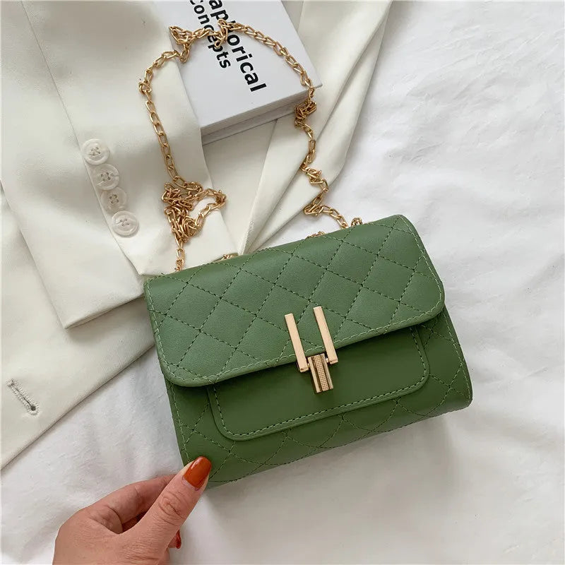 Minimalist women's crossbody bag in vegan PU leather with a diamond lattice chain strap.