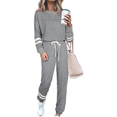 Women's loose-fitting plus size casual suit in a cotton blend, shown in a solid colour with a half-sleeve top and trousers.