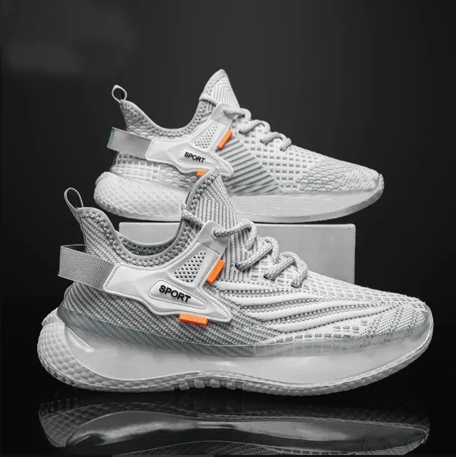 Men's white low-top sneakers with mesh upper and flat rubber sole on a grey background.