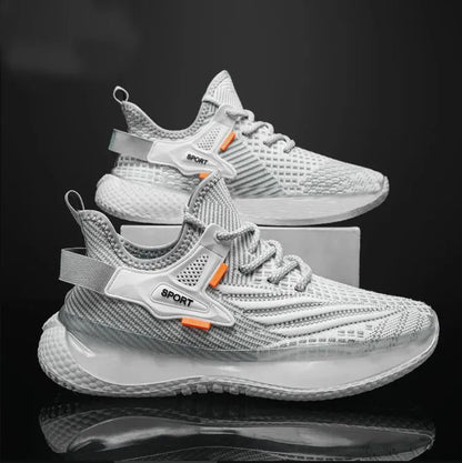 Men's white low-top sneakers with mesh upper and flat rubber sole on a grey background.