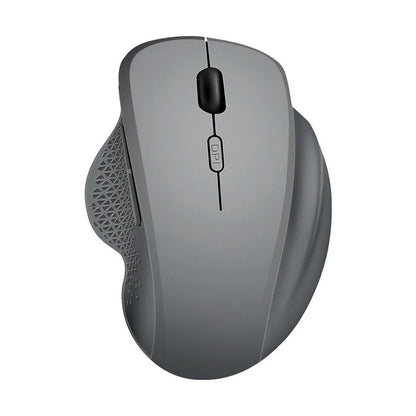 Grey and black wireless notebook mouse with USB charging cable on a laptop keyboard