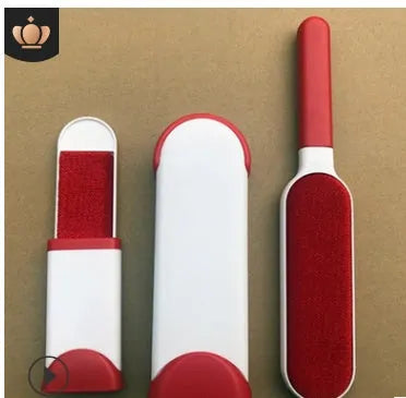 Blue reusable pet hair removal brush with double-sided head next to its self-cleaning base.