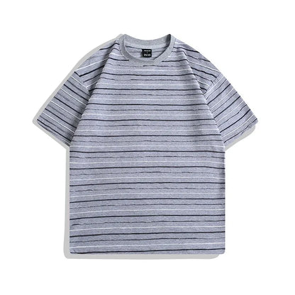 Man wearing a loose-fit striped short sleeve t-shirt with a round neck in a grey colour.