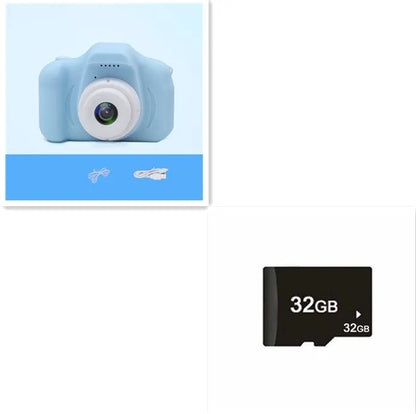 X2 HD mini digital camera for kids in silicone case with lanyard, shown capturing photo on 2-inch screen.