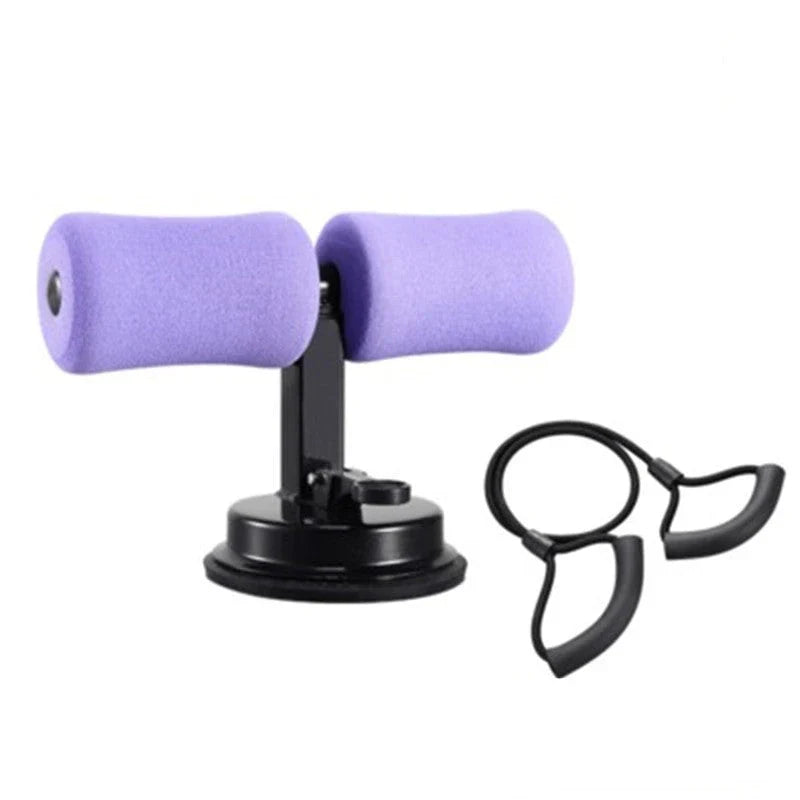 Compact sit-up strength trainer with steel springs and foam padding for home fitness