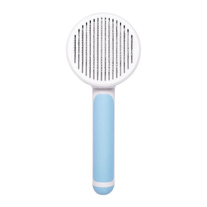 Hand-held pumpkin-coloured pet brush with stainless steel needles for grooming cats and dogs