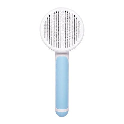 Hand-held pumpkin-coloured pet brush with stainless steel needles for grooming cats and dogs