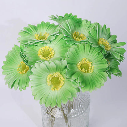 Silk artificial flower bouquet in a white polyurethane pot on a wooden table.