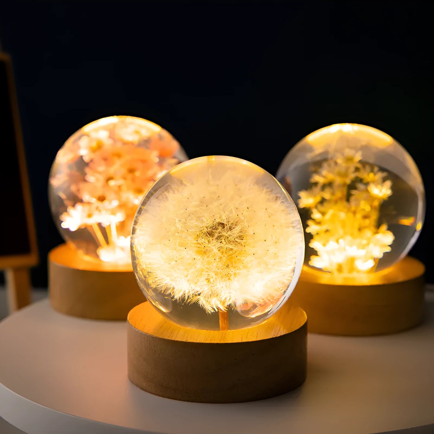 USB-powered 3D dandelion crystal ball night light on a natural beech wood stand.