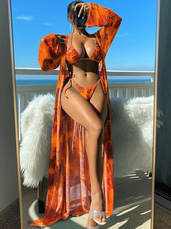 Polyester banded bikini set with long sleeve blouse, briefs, and robe cover-up in floral pattern