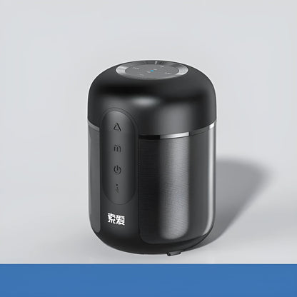 Compact black portable Bluetooth speaker with 30W output and 1500mAh battery, shown on a table.