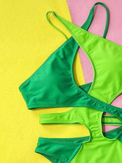Green women's one-piece swimsuit with hollow contrast detail, made from nylon fabric.