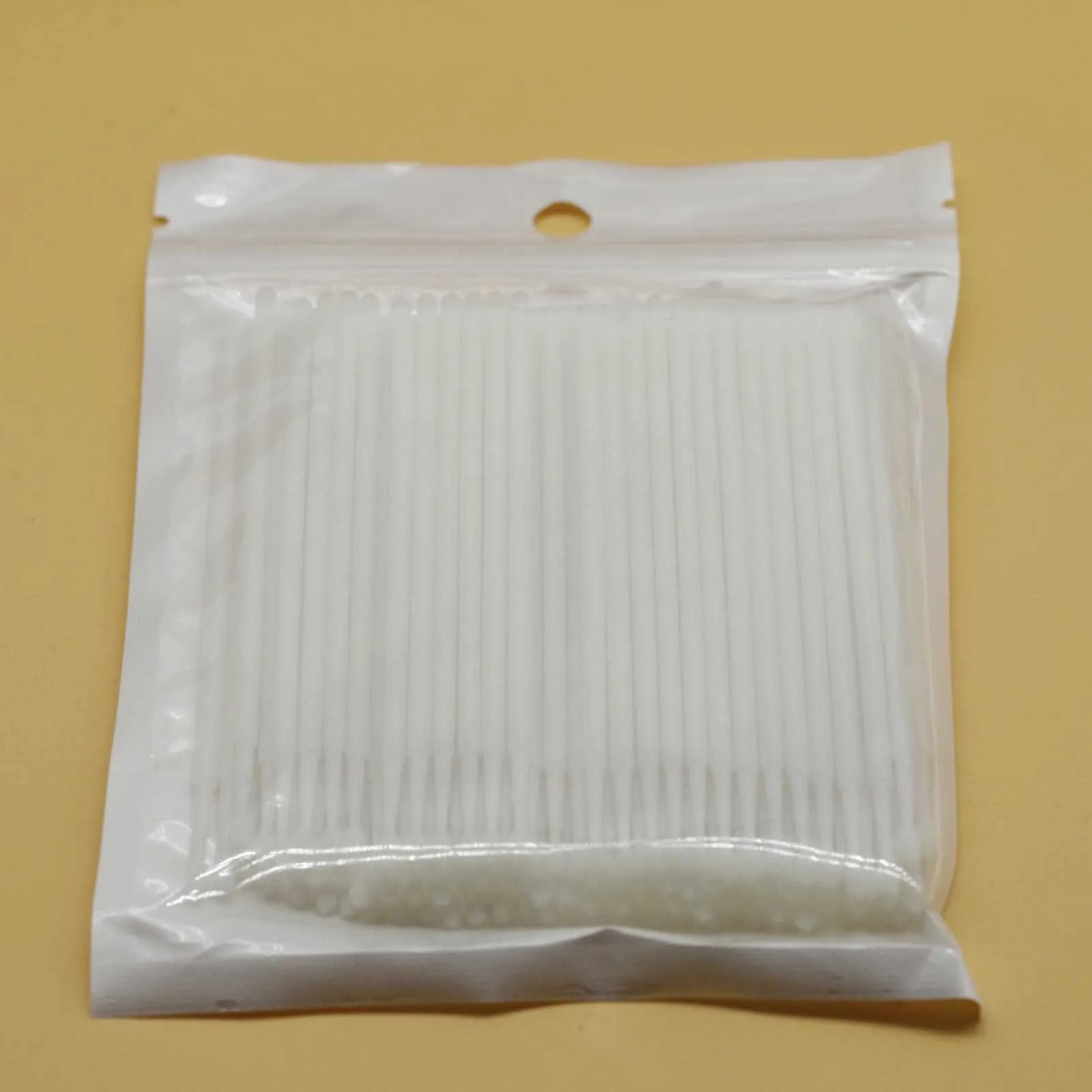 Disposable micro applicator brushes with coloured plastic handles and bendable cotton swab tips