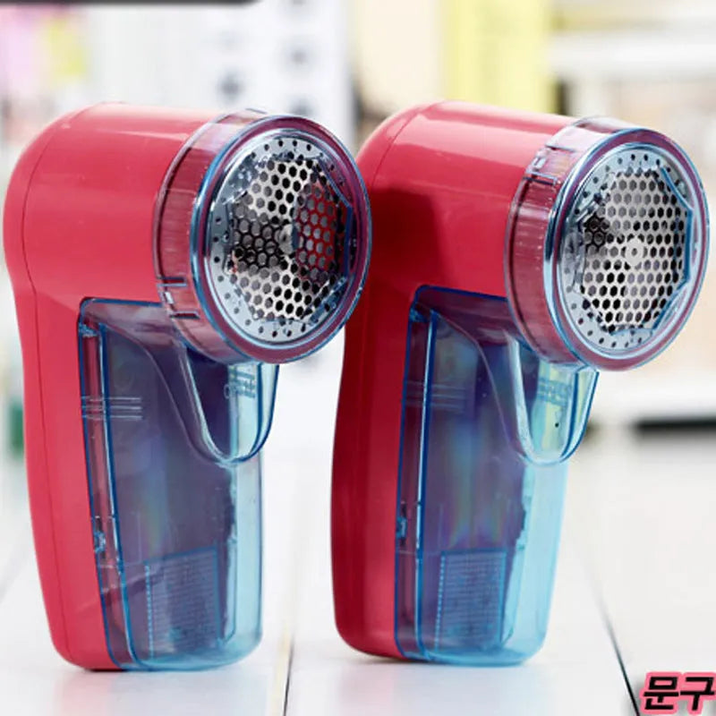 Handheld portable electric lint remover fabric shaver on a blue background.