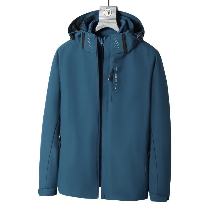 Men's fluorescent coloured waterproof mountaineering suit with removable fleece liner, shown in a hiking setting.