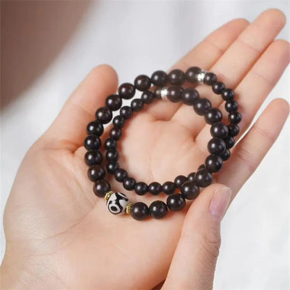 Tibet beads ebony bracelet showing two wooden circles on dark wood with 8mm diameter