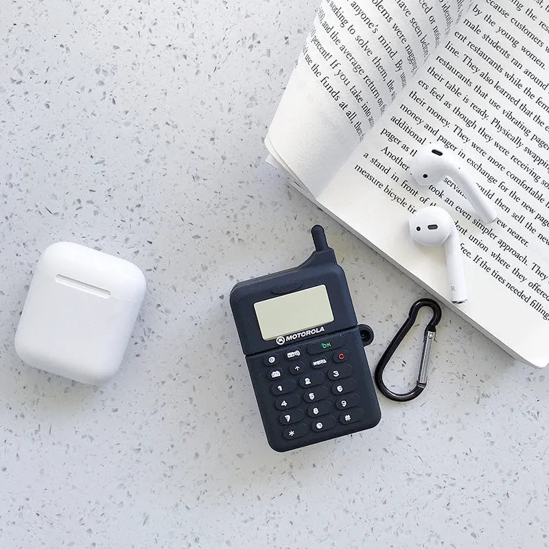 Green silicone AirPods case with raised cartoon animal design, showing charging port cutout.