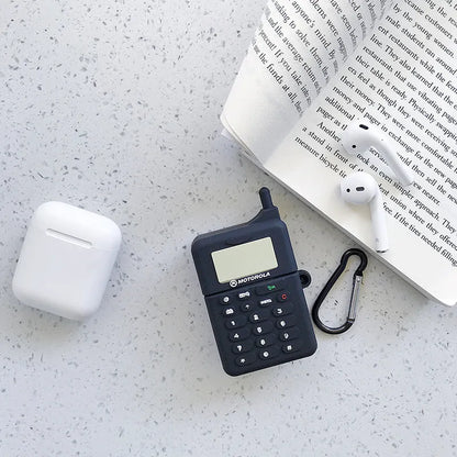 Green silicone AirPods case with raised cartoon animal design, showing charging port cutout.