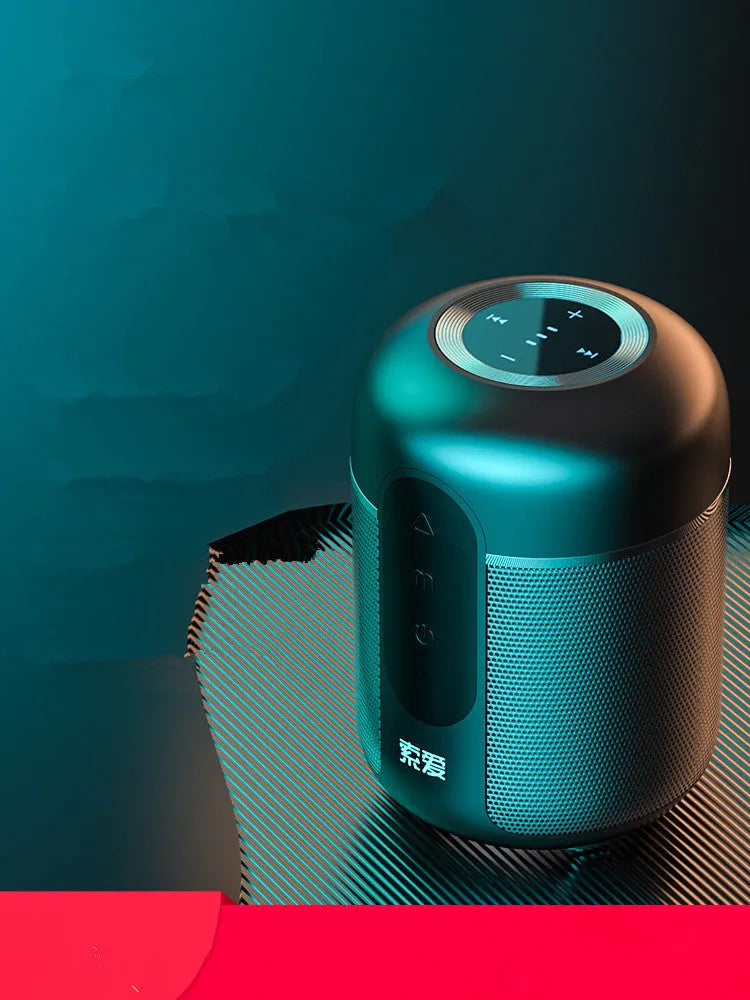 Compact black portable Bluetooth speaker with 30W output and 1500mAh battery, shown on a table.