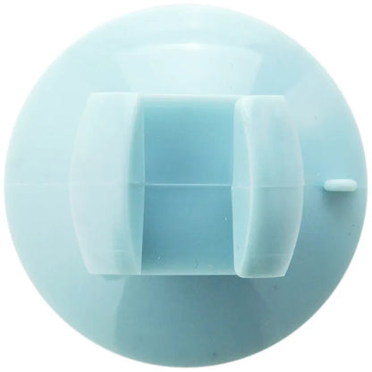 Blue PVC utensil holder with suction cup mounting a rice spoon on kitchen tiles