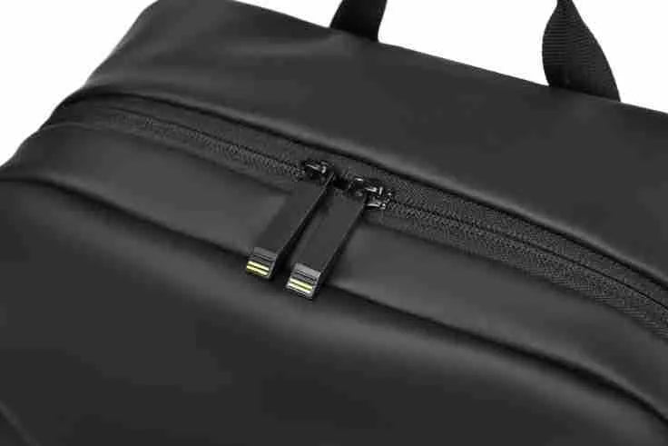 Large black waterproof PU leather laptop backpack with sewing thread details on a simple design.