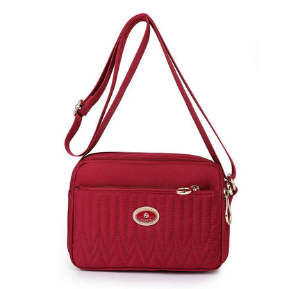 Compact nylon messenger bag for women in various colours with adjustable strap
