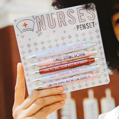 Set of five white plastic retractable ballpoint pens with blue and red nurse-themed text and graphics.