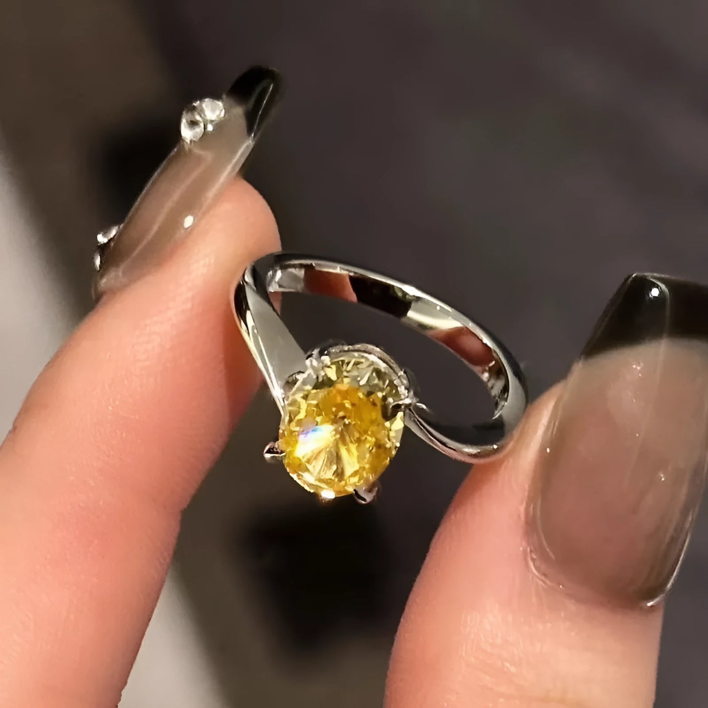 Women's yellow rock sugar crystal copper fashion ring on a hand.