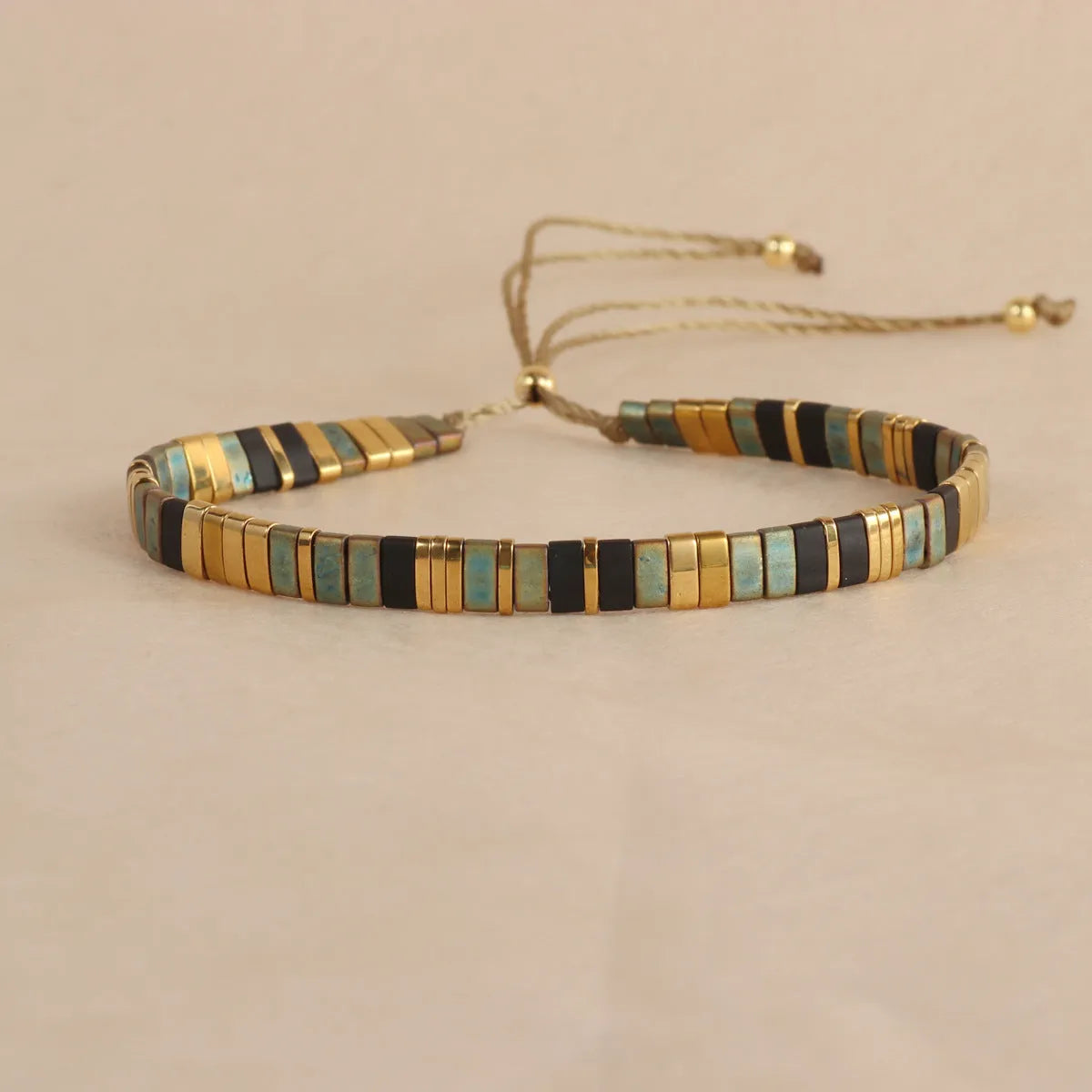 Geometric glass beaded pull bracelet in multiple colours including milky white, black, retro green, light blue, and red
