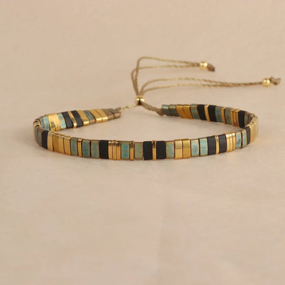 Geometric glass beaded pull bracelet in multiple colours including milky white, black, retro green, light blue, and red