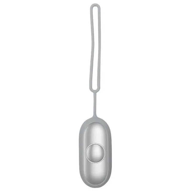 Hand-held micro-current sleep aid device in grey, green, or orange with round button and USB charging port