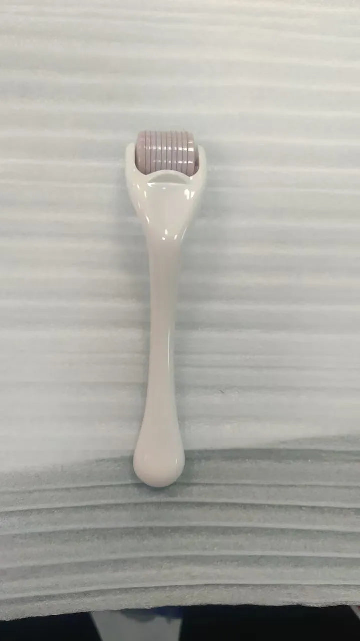 Sterile micro needle derma roller with black handle and coloured wheel on white background