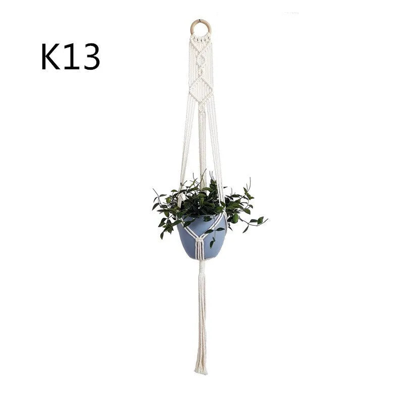 Handmade beige cotton rope net bag holding a plant pot, showing its textured sling design.