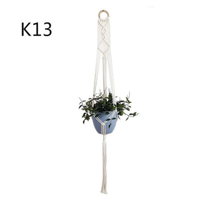 Handmade beige cotton rope net bag holding a plant pot, showing its textured sling design.