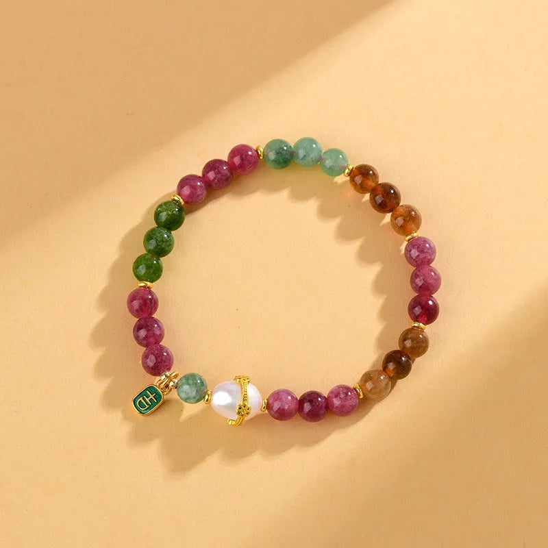 Chalcedony and tourmaline geometric bracelet with 6.5mm beads on a wrist.