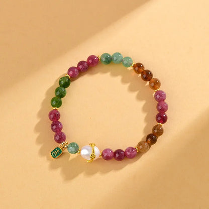 Chalcedony and tourmaline geometric bracelet with 6.5mm beads on a wrist.