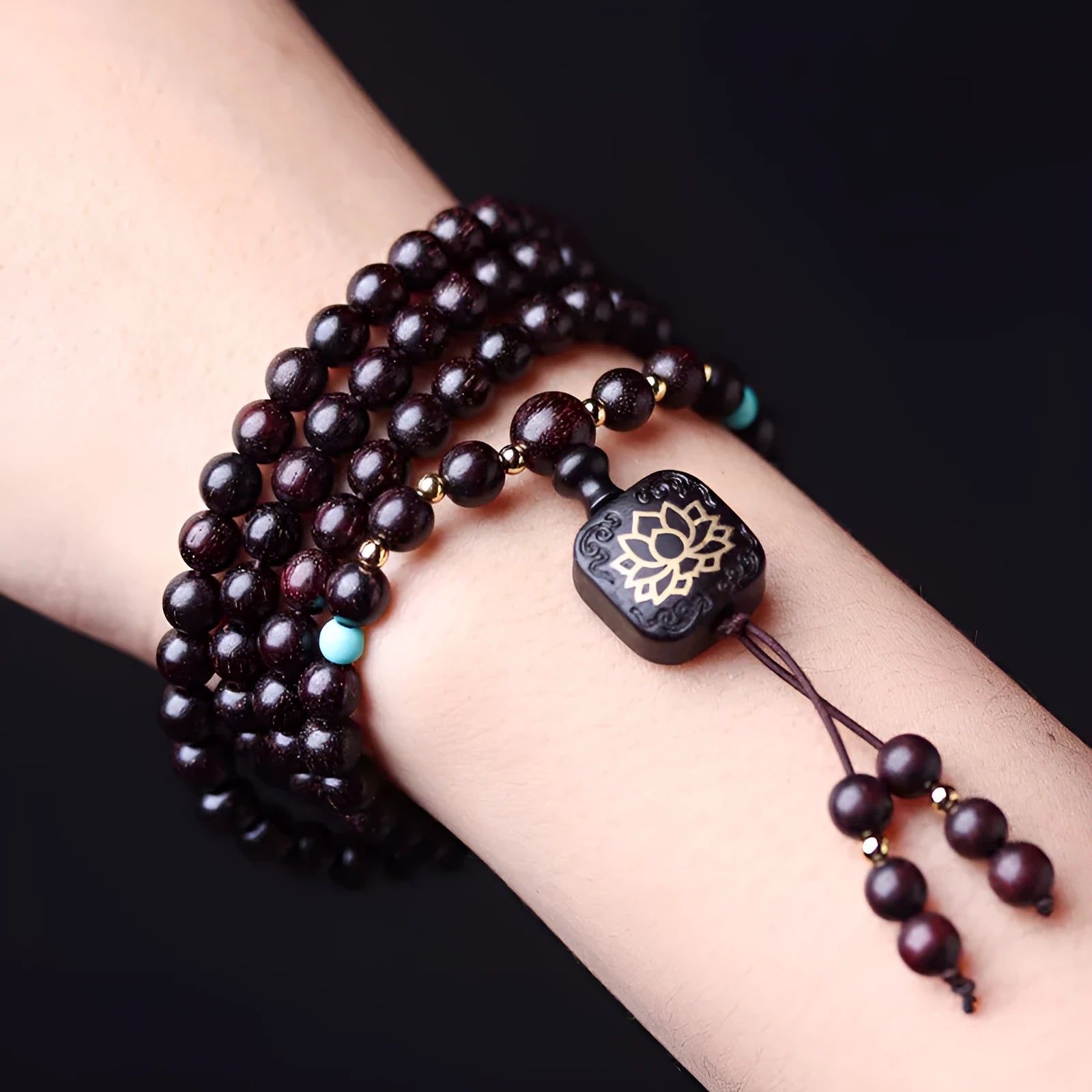 Zambia rosewood bead bracelet with 108 beads and flat lotus pendant on wooden surface