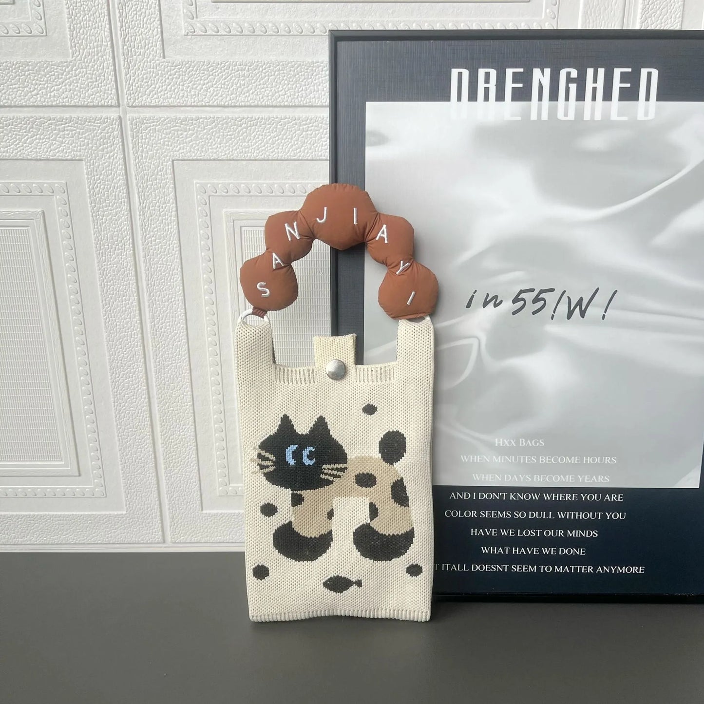 Cartoon knitted messenger bag with polyester construction and internal mobile phone storage