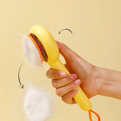 Small yellow duck-shaped plastic comb for grooming cats and dogs, with open needle teeth.