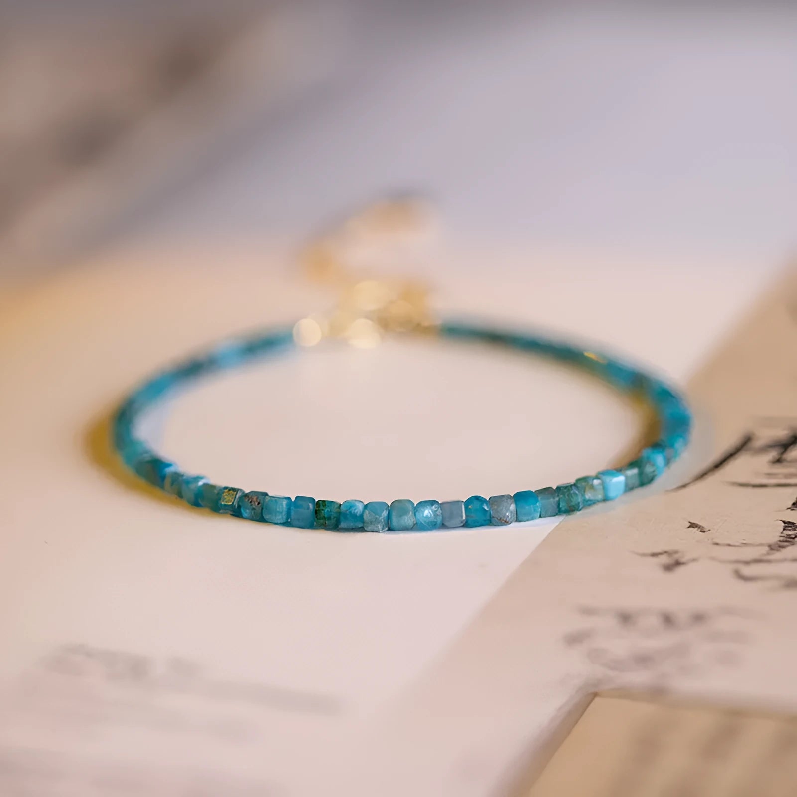 Women's blue apatite crystal bracelet with diamond-cut stones on wrist
