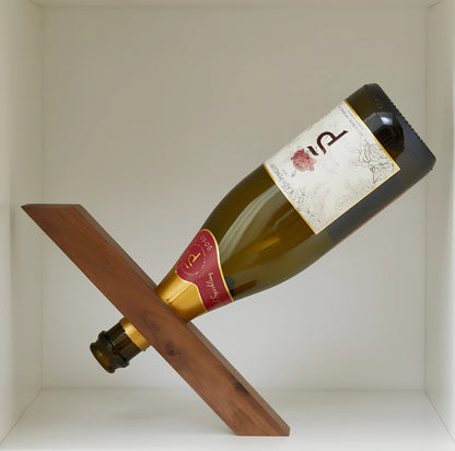 Natural bamboo wine bottle rack holding six bottles with wood grain visible