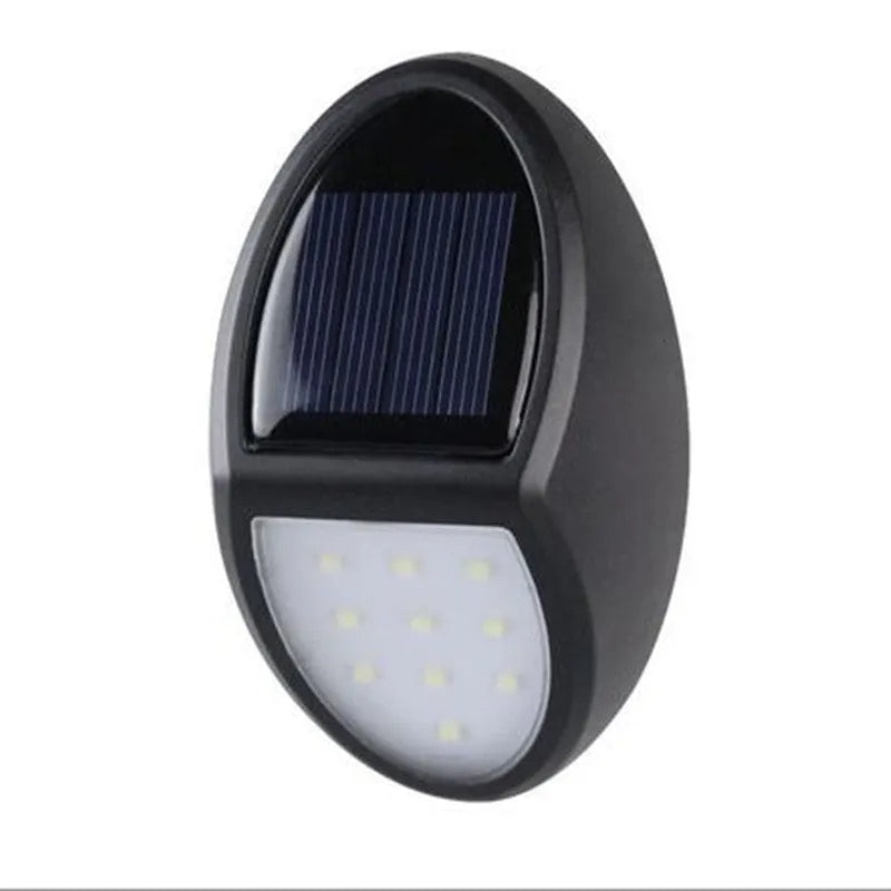 Black rectangular LED solar wall light with solar panel on top for outdoor security.