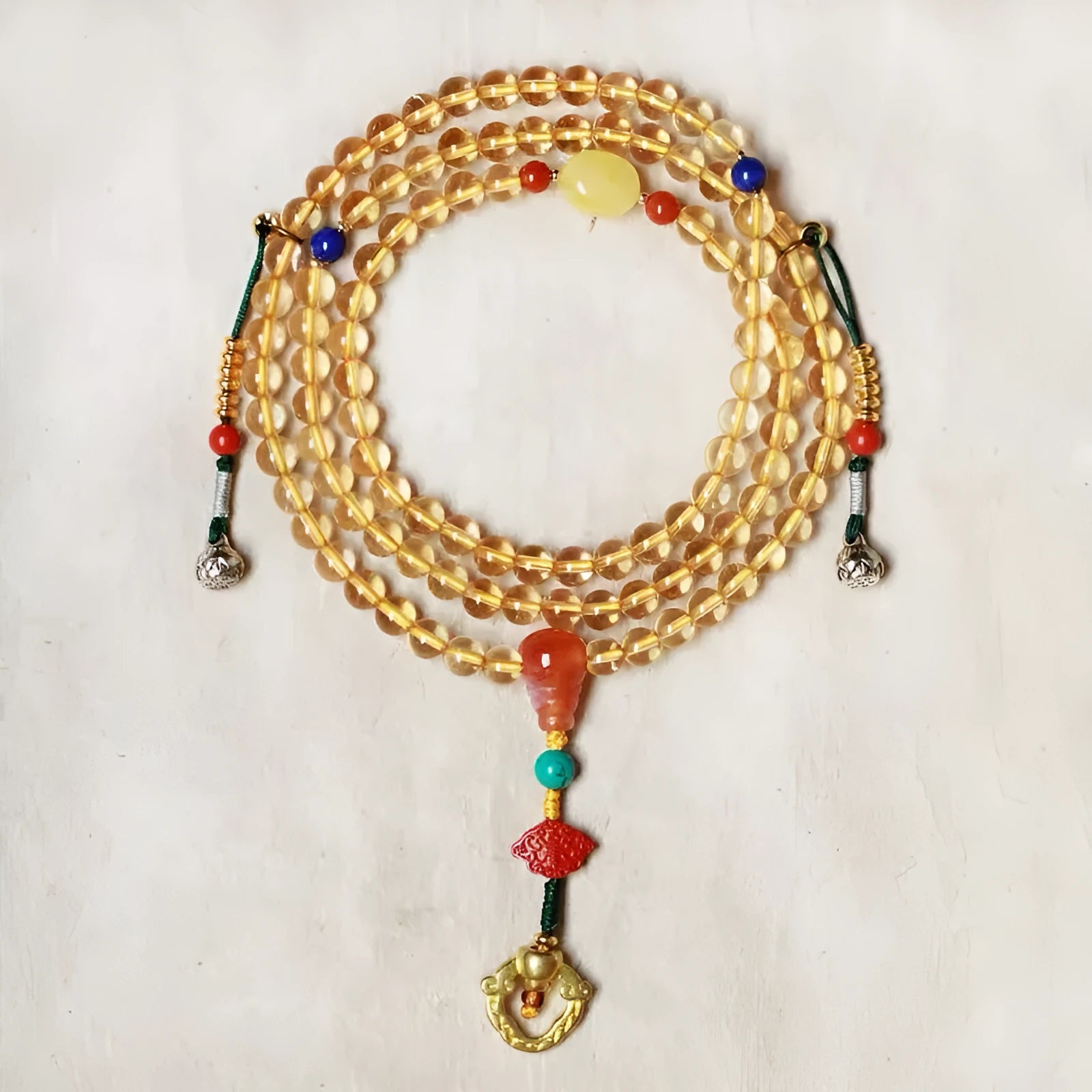 Yellow natural Brazilian citrine bracelet with 1mm beads on a gold-tone filament string.