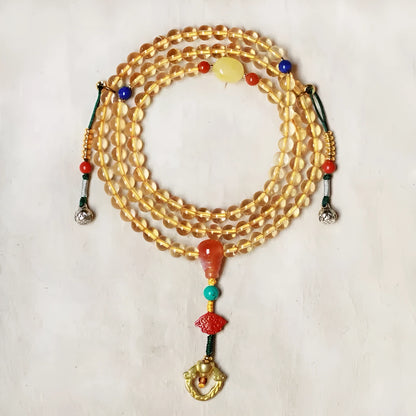 Yellow natural Brazilian citrine bracelet with 1mm beads on a gold-tone filament string.