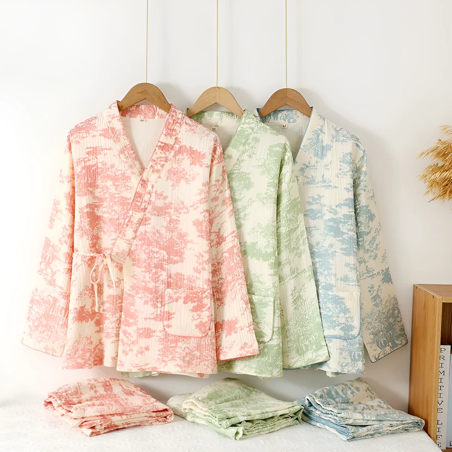 Women's pink pure cotton gauze lace-up top and trousers homewear set laid flat.