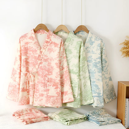 Women's pink pure cotton gauze lace-up top and trousers homewear set laid flat.
