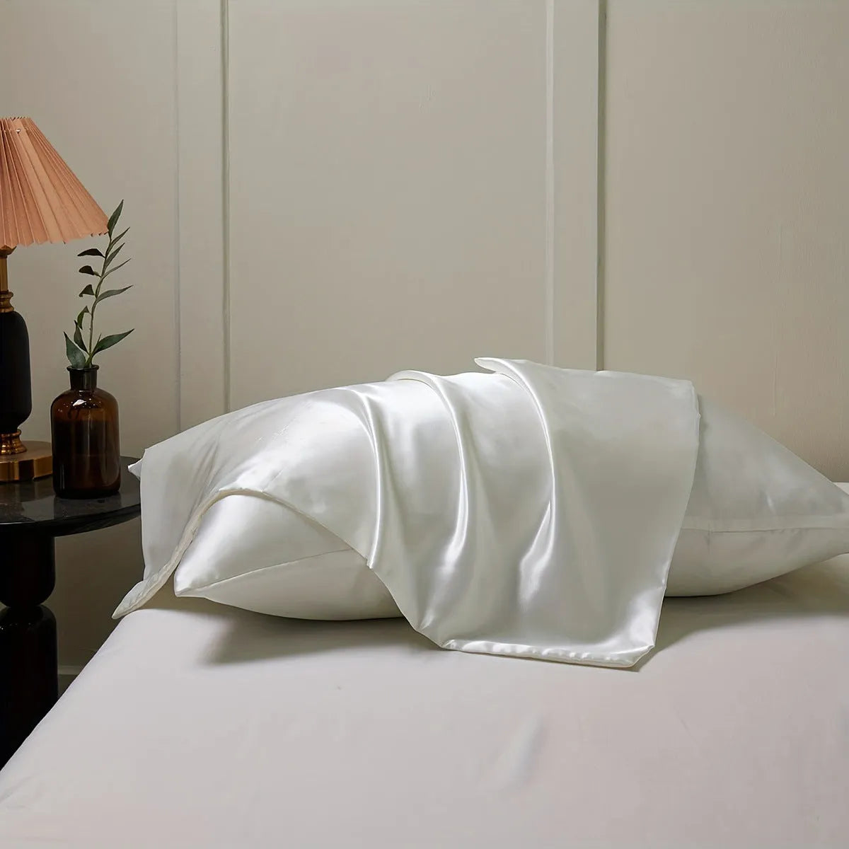 Pair of solid colour satin pillowcases showing smooth plain weave texture and reactive dye colour